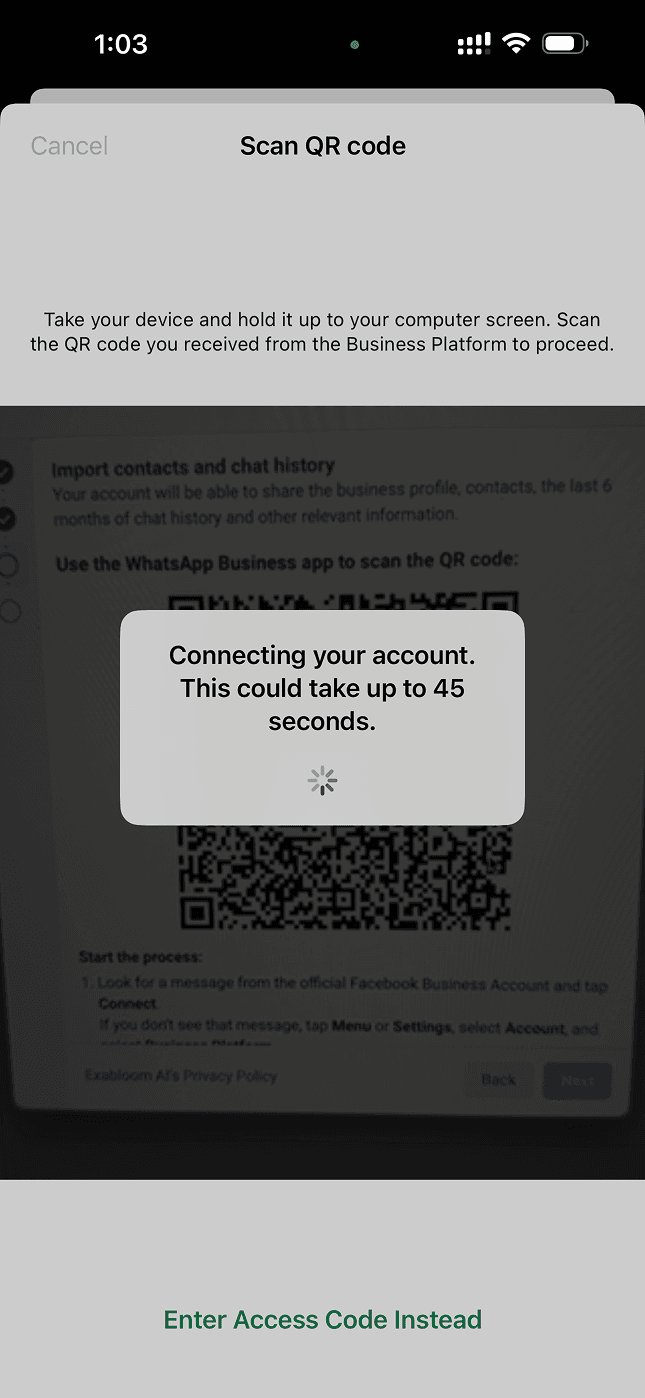 The phone camera open, scanning the QR code on the computer screen
